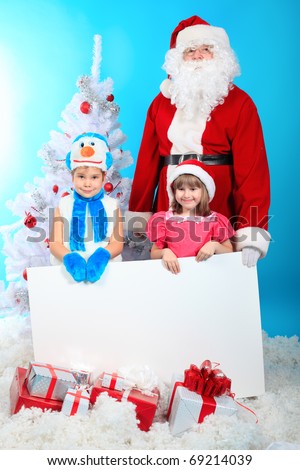 Christmas theme: Santa Claus and little children holding white board.