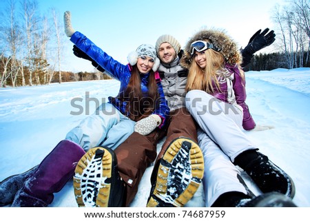 Group of young people having winter rest outdoor.
