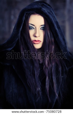 Shot of a gothic woman in a winter park. Fashion.