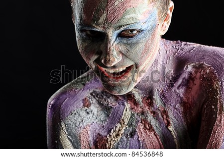 Portrait of an artistic woman painted in metal style. Shot in a studio.