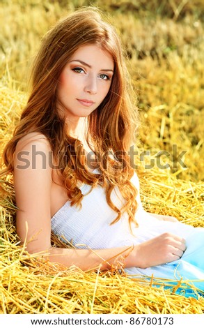 Romantic young woman posing outdoor.