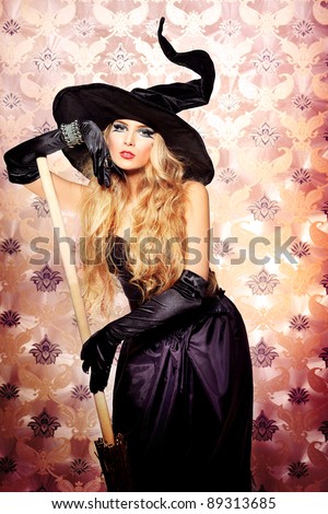 Charming halloween witch over vintage background.