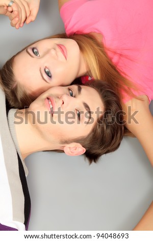 Happy smiling couple in love.  Over grey background.