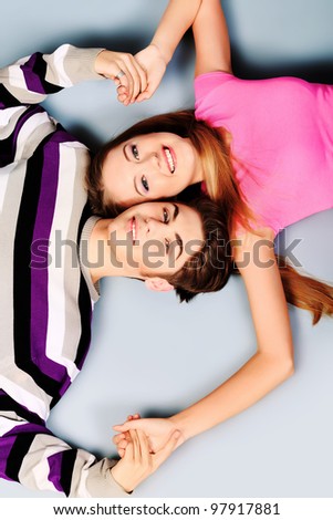 Happy smiling couple in love.  Over grey background.