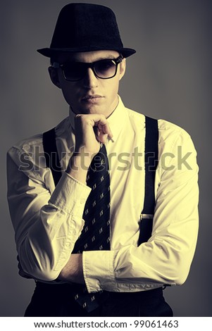 Portrait of a handsome young man in a suit. Shot in a studio.