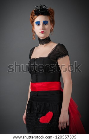 Young girl in the image of the Queen of Hearts from \