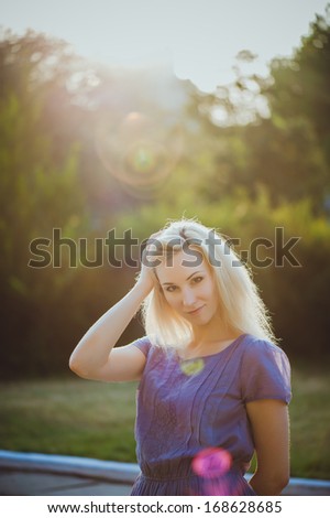 Portrait of young girl outdoors with sunbeams