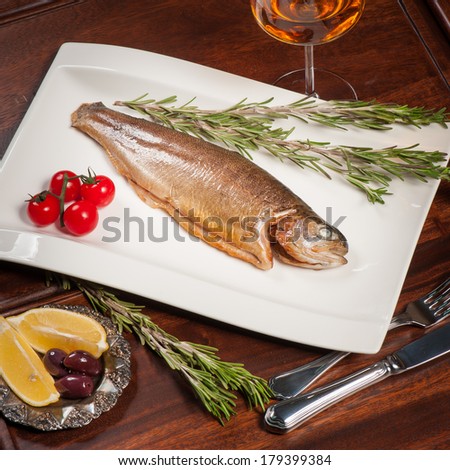 Grilled fish with rosemary, tomatoes and white wine