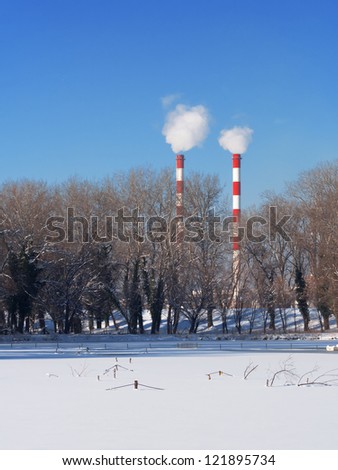 Smoking pipe chimneys near water, Belgrade Serbia, river Sava , frozen river