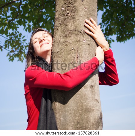 Portrait of a beautiful young woman hugging a tree in fall season,  i love tree