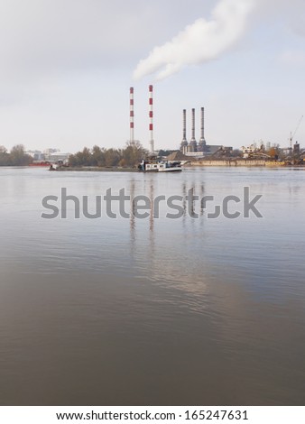 Smoking chimneys pollution air near water, Belgrade Serbia, river Sava