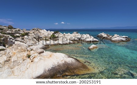 Paradise bay beach in Aegean sea, untouched nature abstract archipelago in seashore with rocks in water on peninsula Halkidiki, Greece