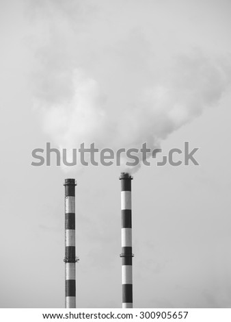 Two smoking chimneys pollution air