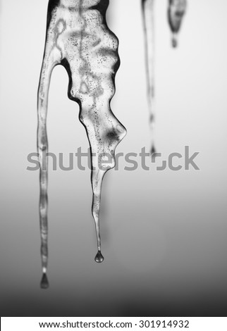Abstract frozen thawing icicles with sunlight in background