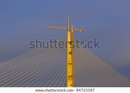 Part of construction of new Belgrade biggest bridge with one tower ( pilon) in the world end hoisting crane / river Sava, Serbia / under construction / one pylon / wide angle lens