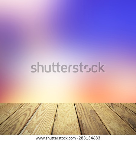 Empty wood table over blurred blue sky with bokeh background, product display template,deck,