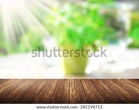Empty wood table over blurred green plant with bokeh background, product display template,deck,