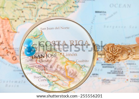 Blue tack on map of Central America with magnifying glass looking in on San Jose, Costa Rica
