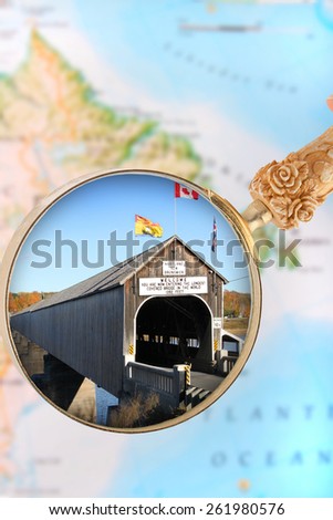 Magnifying glass or loop looking in on the longest, wooden covered bridge in the world, Hartland, New Brunswick, in the Maritime provinces of Canada