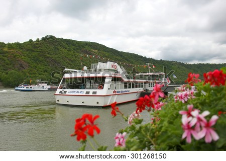 RHINE RIVER, GERMANY, JUNE 21, 2015: Tour boat at dock waiting to load for a cruise down the Rhine River in Germany