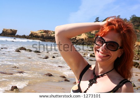woman smiling at the beach in the Algarve, Portugal