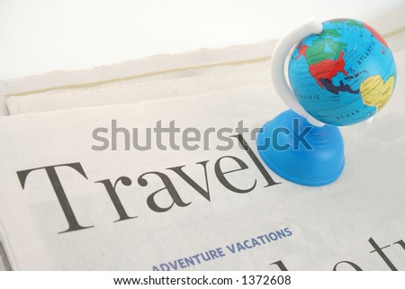 travel section of newspaper and globe