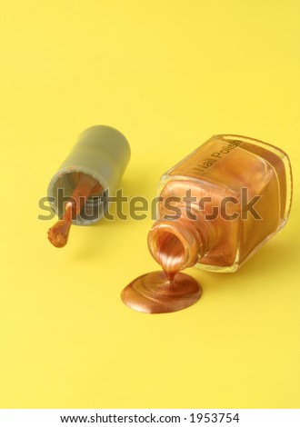 metallic gold nailpolish spilling from the bottle