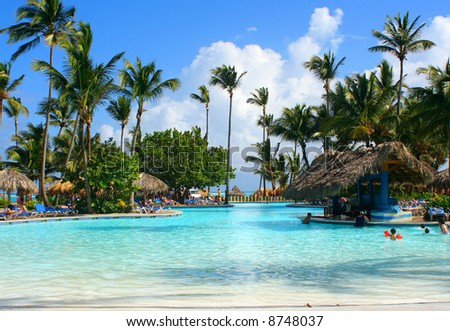 tropical pool bar with families enjoying their vacation at a Caribbean resort