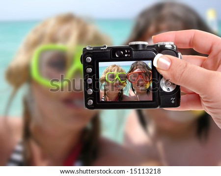 male and female getting a photograph taken while snorkeling in the tropics