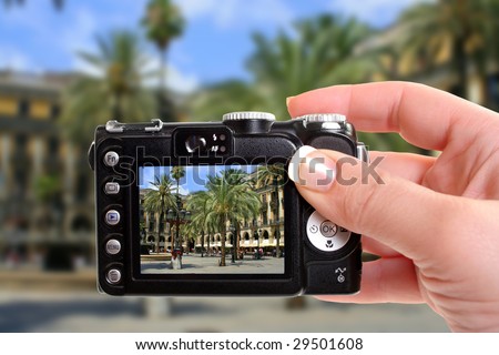 taking a picture of a Spanish plaza with restaurants in Barcelona, Spain