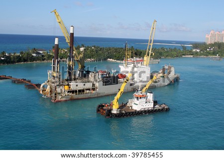 Industrial ship that digs sand making harbor deeper for bigger ships to be able to dock in Nassau port in the Bahamas