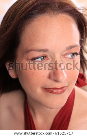 Pretty woman around forty years old showing close up of her beautiful aging skin