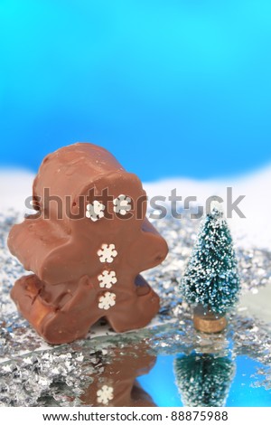Fantasy chocolate fudge snowman in wonderland with frozen pond and snow