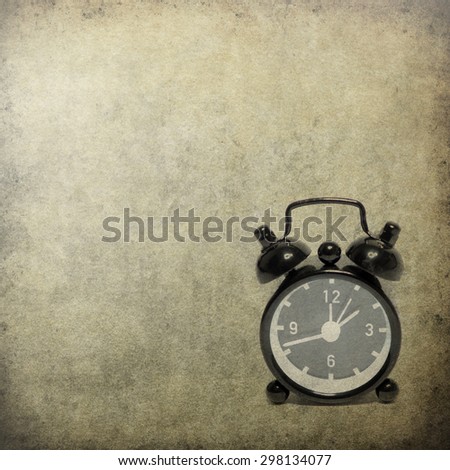 old alarm clock on old background texture