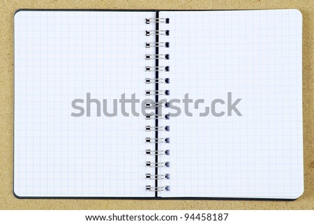 pencil and notebook on woods