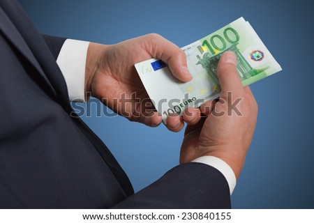 Man counts money euro  isolated on blue background