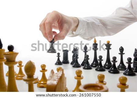Business concept strategy, leadership, team and success. Businessman playing chess game selective focus. Makes first move
