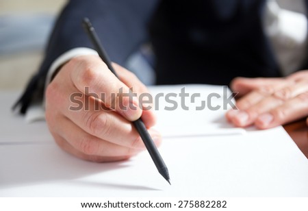 Hands signing business documents.Signing papers. Lawyer, realtor, businessman sign documents.