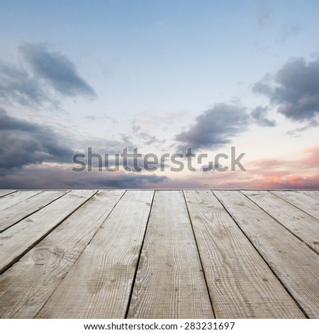 Wooden perspective floor with planks on sky background, can use for display or montage your products template. Copy space