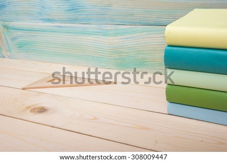 Back to school. Stack of colorful books on wooden table. Composition with vintage old hardback books, diary on wooden deck table. Books stacking. Copy Space. Education background. Selective focus