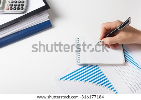 Businessman counting losses and profit working with statistics, analyzing financial the results on white background. Copy space