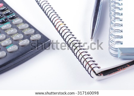 Concept of counting losses and profit working with statistics, analyzing financial the results on white background. Copy space. Businessmen's workplace, calculator, pen, book, diary on table