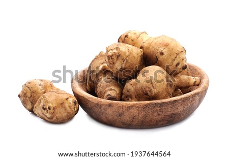 Similar – Image, Stock Photo Plate with raw Jerusalem artichoke on concrete kitchen table with olive oil, herbs and spices. Cooking preparation at home with root vegetable. Top view.