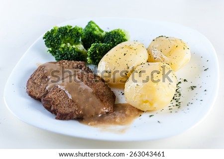 Beef chop with potatoes and broccoli