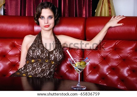 The posing girl at restaurant in style old-fashioned