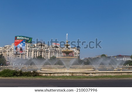 Bucharest, Romania - August 10, 2014: The water fountains in Unirii Square cool down the atmosphere on a hot summer\'s day on 10th of August 2014 in Bucharest Romania..