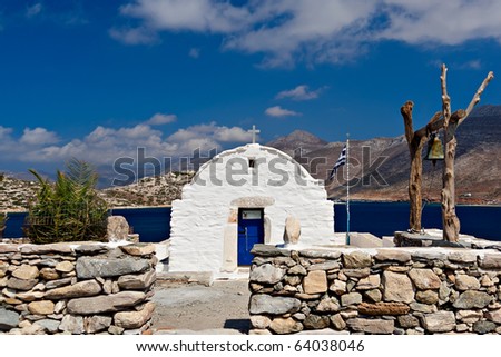 Orthodox white church with wooden church-bell in Cyclades, Greece