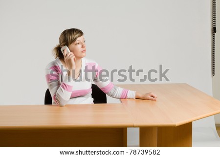 young pretty girl seated at the table