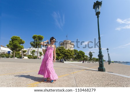 Girl posing in front of the white tower at Thessaloniki city in Greece