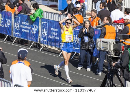 ATHENS,GREECE - NOV 11: 30th Athens Classic Marathon. Greece's George Karavidas reaching the finish line at the Panathenean stadium November 11, 2012 in Athens,Greece